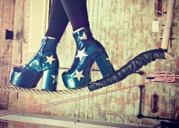 Walking on a Rope Wearing Vegan Stardust Metallic Teal Platform Ankle Boots with Silver Stars